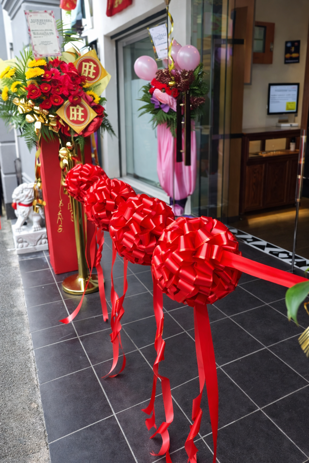Opening ceremony ribbon cutting setup with red ribbon balls