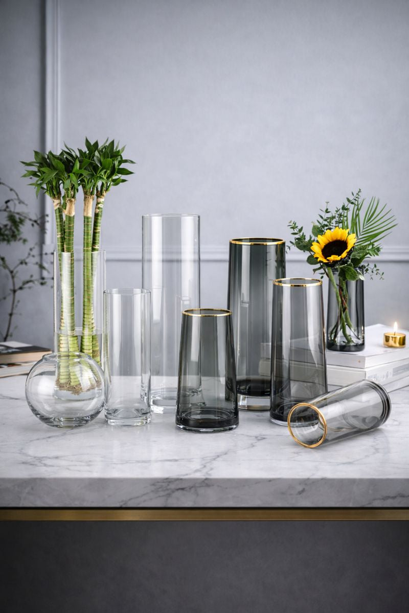 Assorted glass vases in clear and smoke grey with gold rims