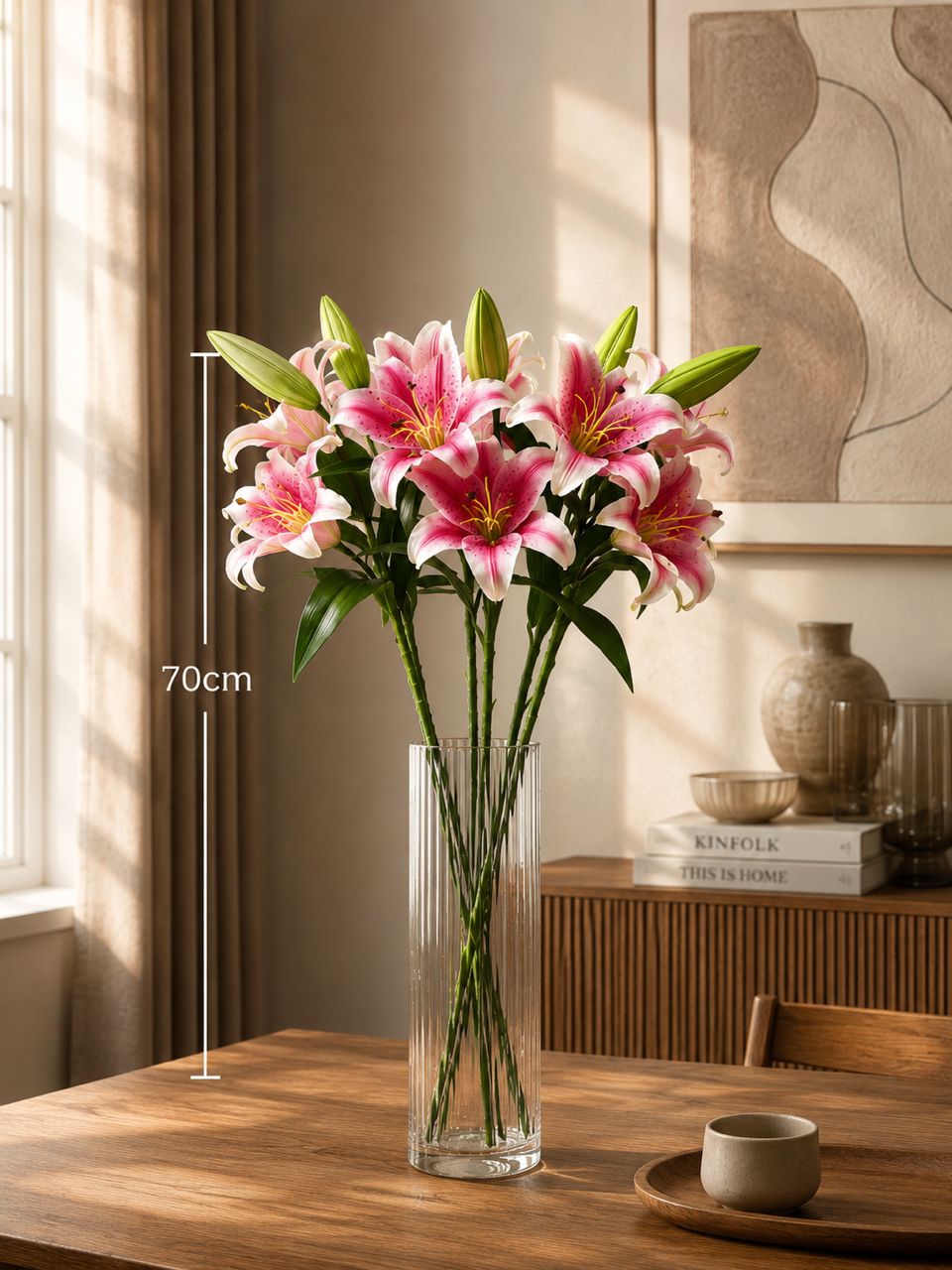 Red glass vase with six artificial lily stalks, perfect for home decor, garden, or event decoration by Alton Flowers.