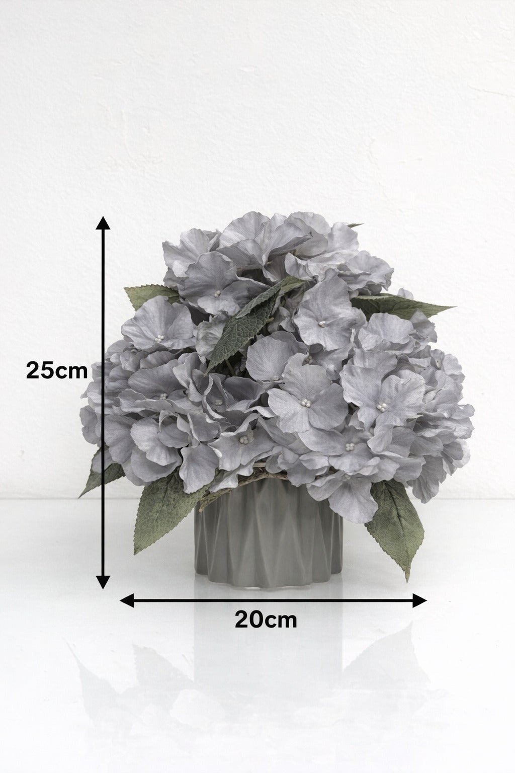 Artificial hydrangea flower arrangement by Alton Flowers, 25cm elegant faux hydrangeas in vibrant blooms with lush green leaves.