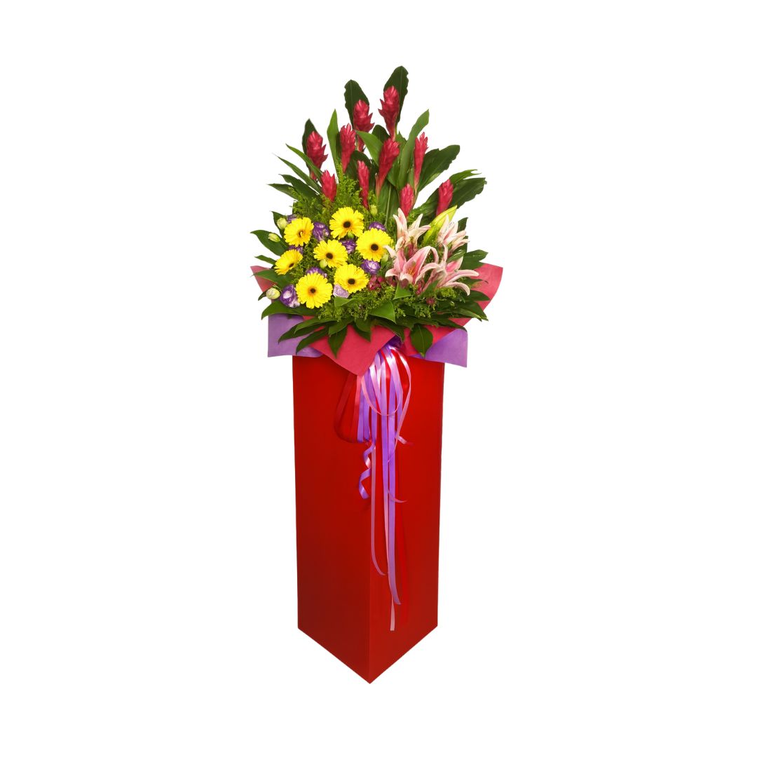 Colorful Grand opening flower arrangement on a red stand with a white background