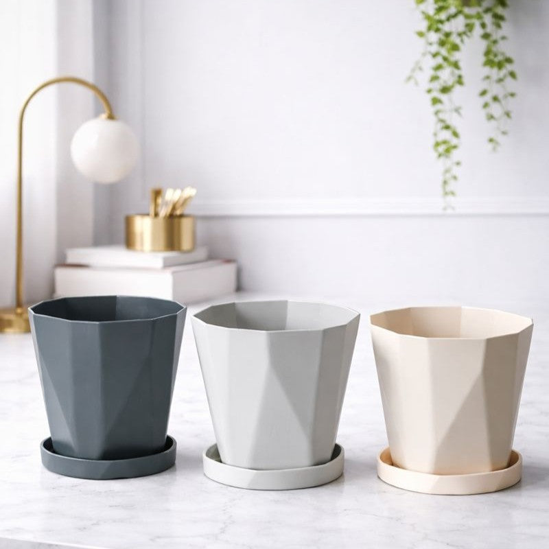 Modern faceted plant pots with matching saucers in grey and beige