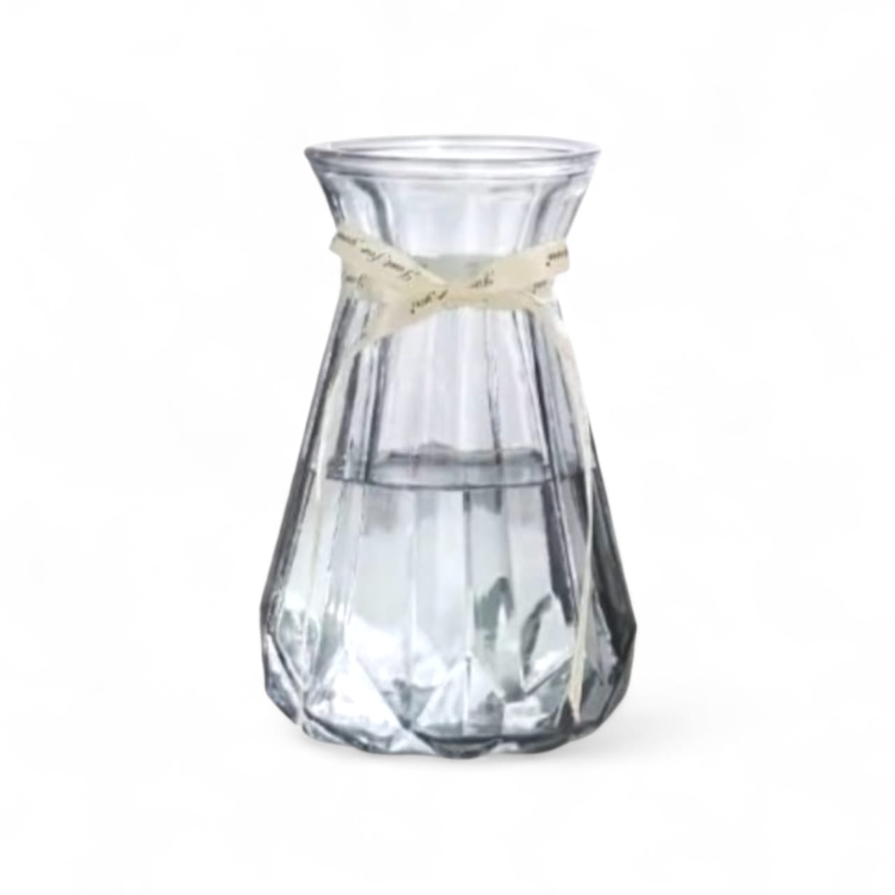 Clear glass vase with a beige ribbon on a white background