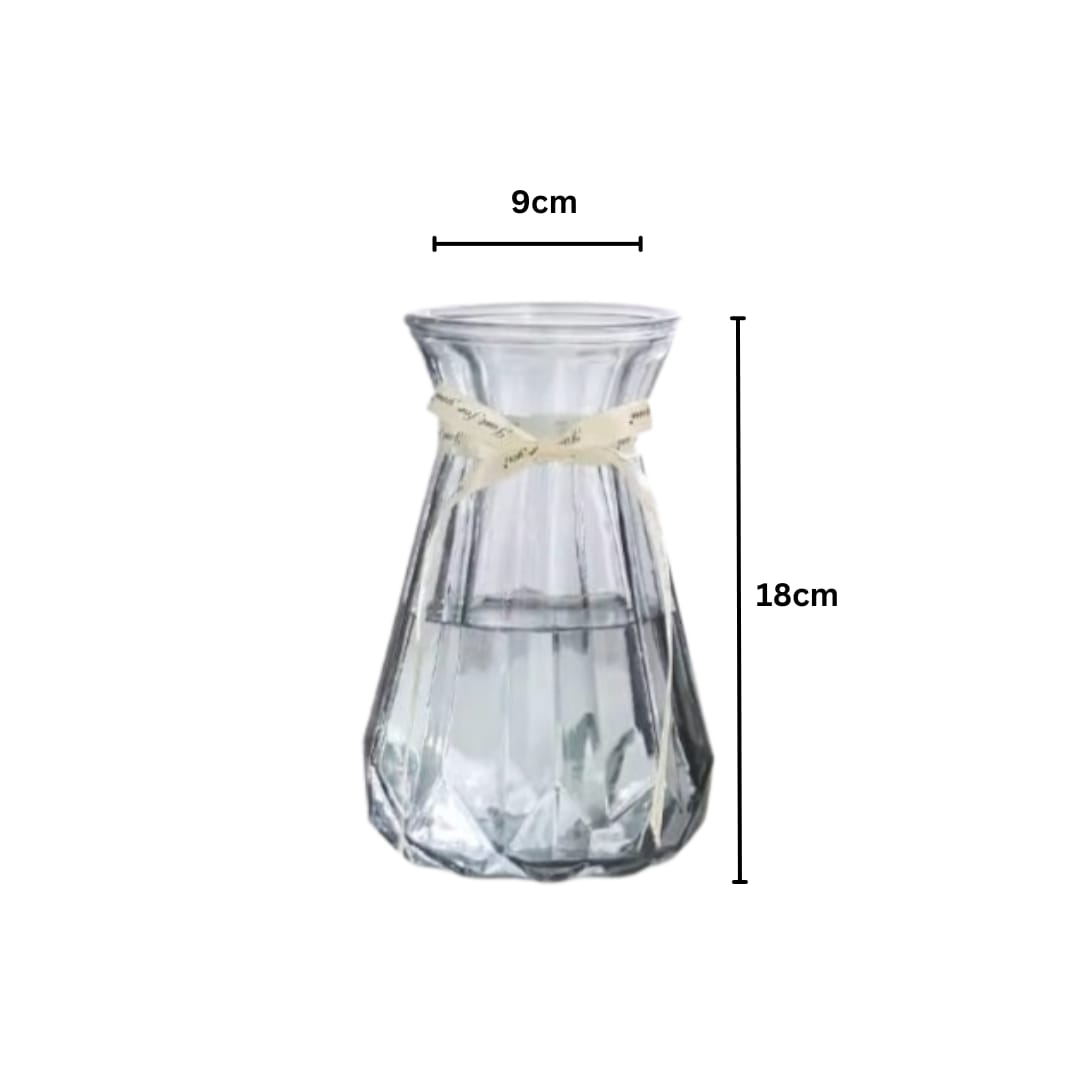 Clear glass vase with a beige ribbon measurement on a white background