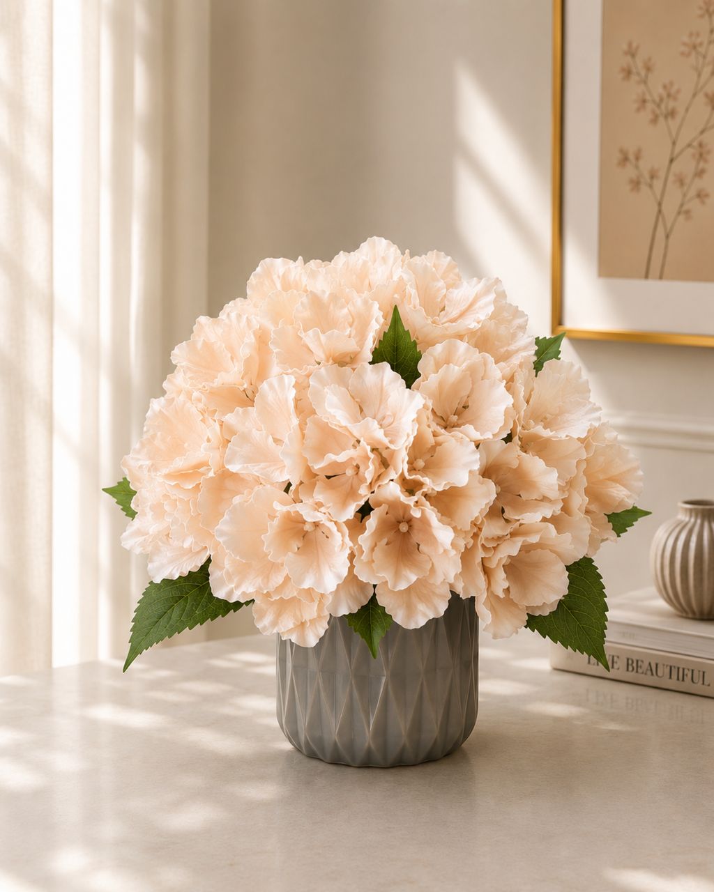 Artificial peach hydrangea flower in a pot by Alton Flowers, showcasing realistic blooms and lush green foliage.
