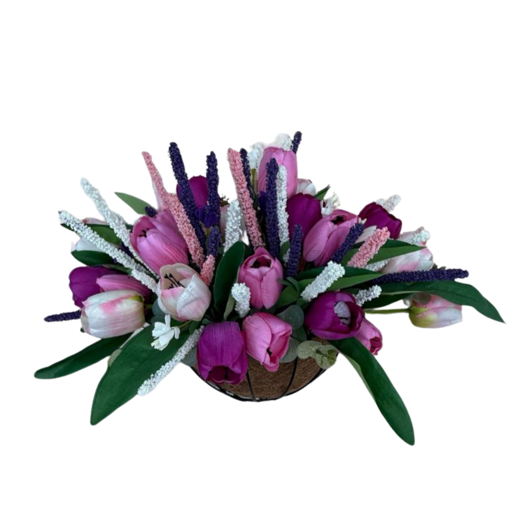 Bouquet of pink and purple tulips with green leaves on a white background
