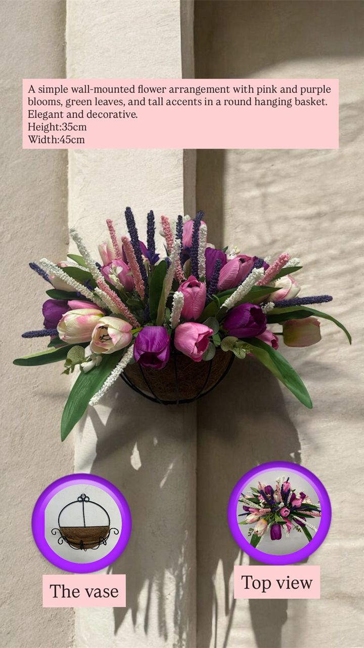 Wall-mounted flower arrangement with pink and purple blooms, green leaves, and tall accents in a round hanging basket.