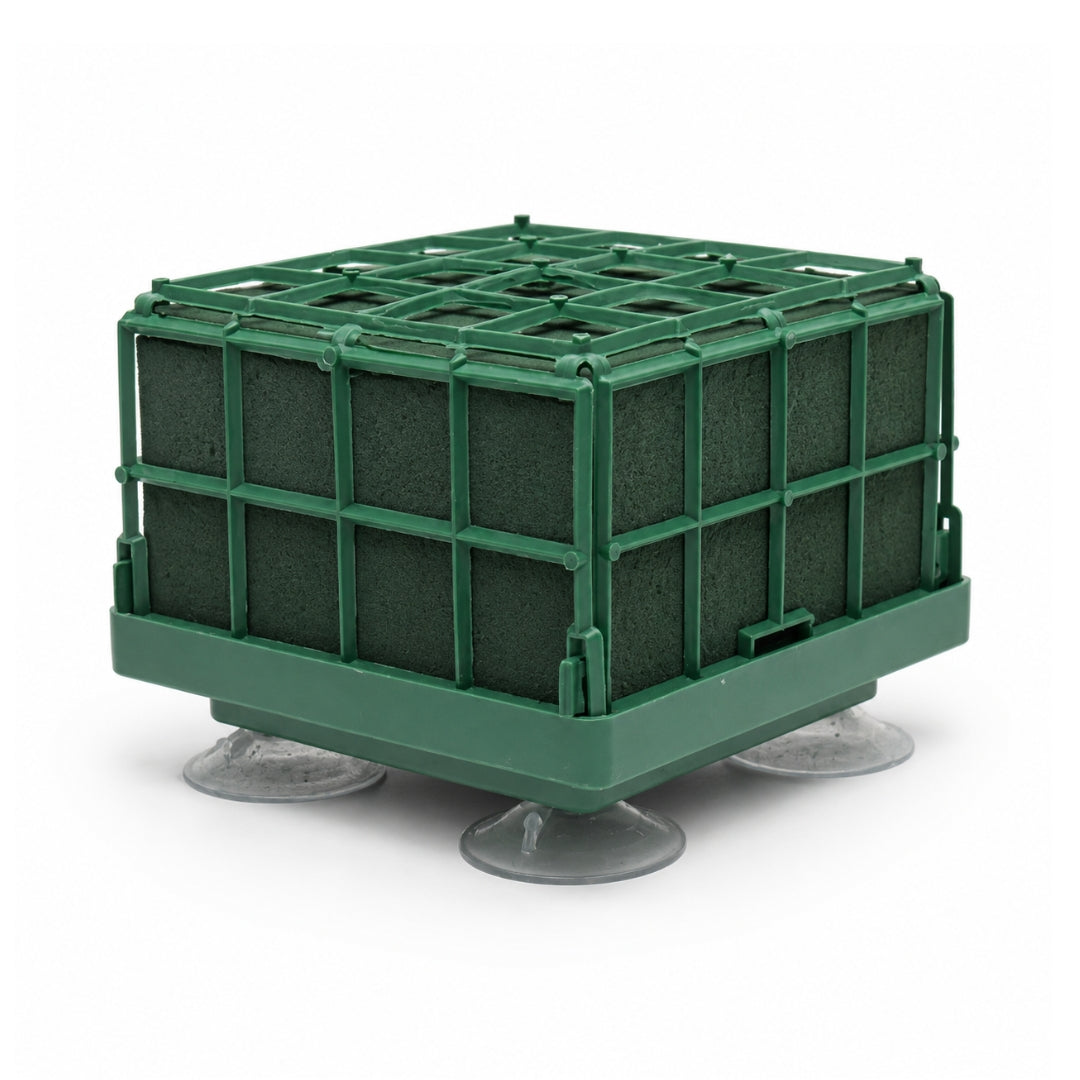 An 11x11x8cm green bridal car floral foam brick enclosed in a green plastic cage with four clear suction cups on the bottom base.