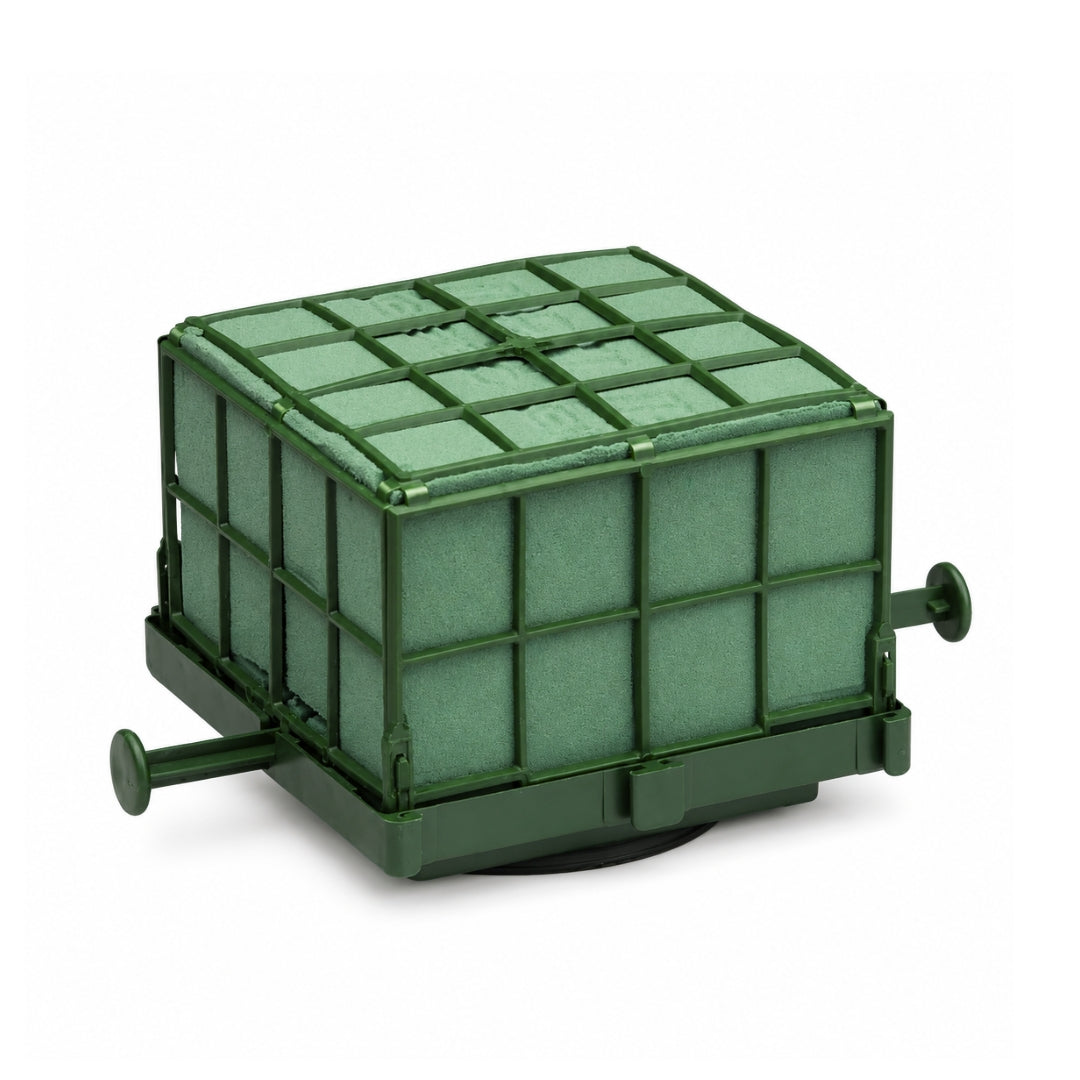 An 11x11x9cm green Oasis Auto Corso bridal car floral foam block inside a protective cage with a bottom suction pad.