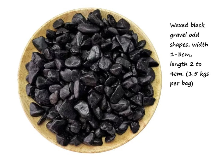 Round black waxed gravel 1-2cm from Alton Flowers, showing smooth, polished stones suitable for landscaping and decorative uses.