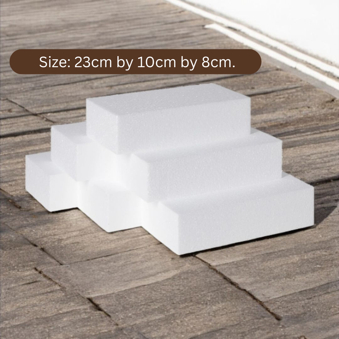 Six white polystyrene foam craft blocks measuring 23cm by 10cm by 8cm, stacked on a wooden surface.