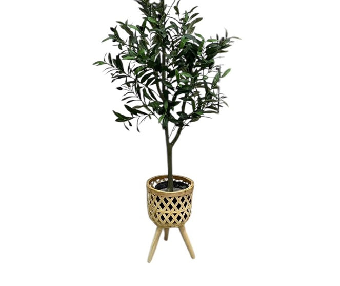 Small artificial olive tree in a woven bamboo planter basket with three tapered wooden legs, suitable for indoor home decor.