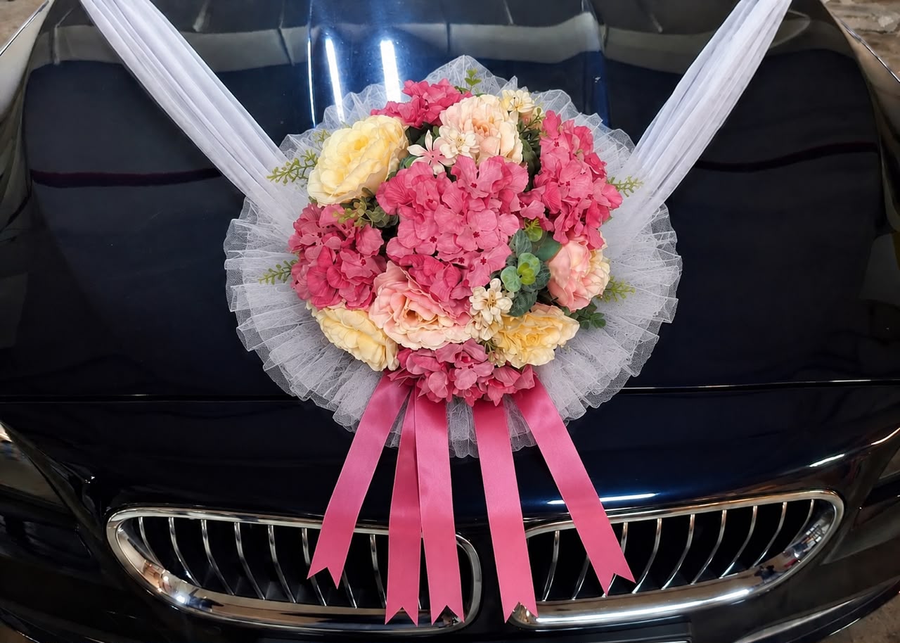 Alton Flowers handcrafted bridal wedding car decoration with silk floral bouquet and ribbon on the front bonnet.