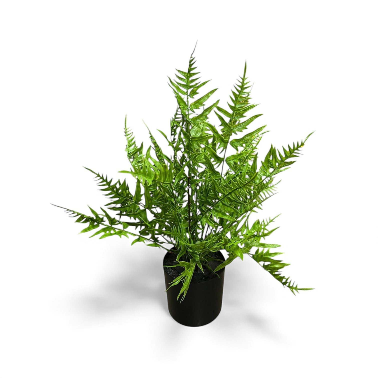 Artificial green fern plant with serrated leaves in a sleek black pot for maintenance-free indoor or outdoor decor.