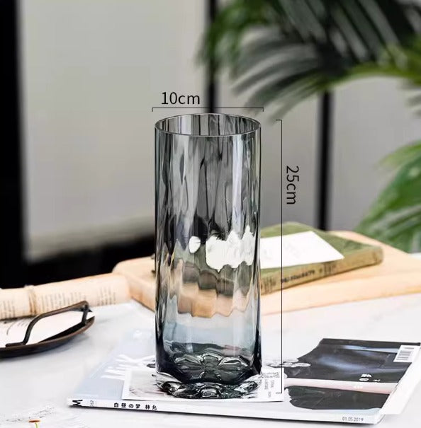 Tall smoky grey textured cylindrical glass vase measuring 10cm by 25cm, suitable for modern home decor or floral arrangements.